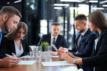startup business team on meeting in modern bright office interior brainstorming, working on laptop and tablet computer