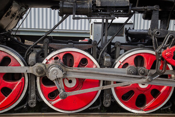 An old steam locomotive of the early 20th century on the railway track.