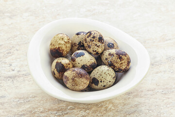 Raw quail eggs heap in the bowl