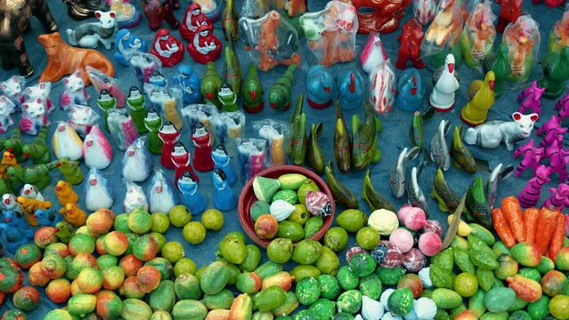 A colorful array of clay toys is displayed in a shop at a village fair in Bangladesh. Parents and children alike are drawn to the shop, their eyes sparkling with excitement and joy. 