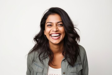 Medium shot portrait of an Indian woman in her 30s against a white background