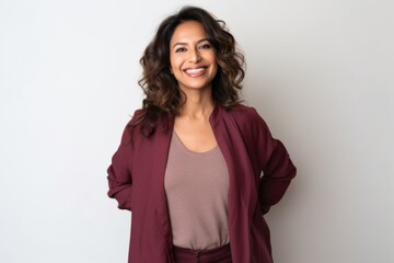 Fototapeta premium Medium shot portrait of an Indian woman in her 40s against a white background