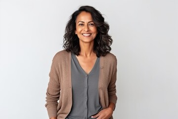 Fototapeta premium Medium shot portrait of an Indian woman in her 40s against a white background