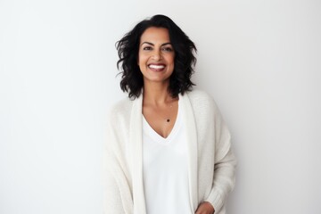 Fototapeta premium Medium shot portrait of an Indian woman in her 40s against a white background