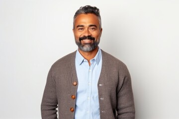 Medium shot portrait of an Indian man in his 40s against a white background