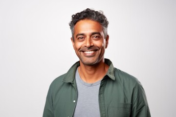 Medium shot portrait of an Indian man in his 40s against a white background