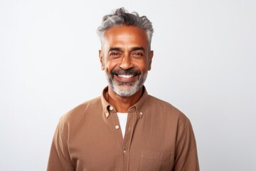 Obraz premium Medium shot portrait of an Indian man in his 50s against a white background
