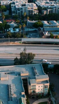 Traffic on freeway in downtown los angeles. Cityscape downtown view of traffic on the freeway in Los Angeles. Aerial vertical, vertical video background.