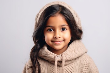 Lifestyle portrait of an Indian child female in a minimalist background