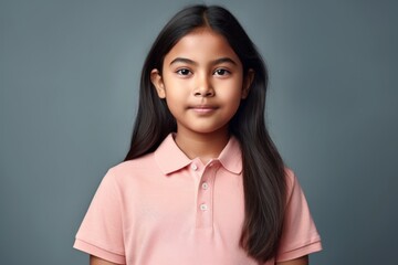 Lifestyle portrait of an Indian child female wearing a sporty polo shirt in a minimalist background