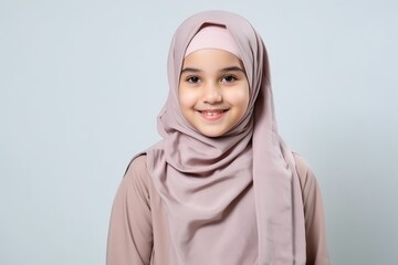 Medium shot portrait of an Indian child female wearing hijab in a minimalist background