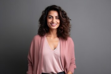 Fototapeta premium Medium shot portrait of an Indian woman in her 30s in a minimalist background