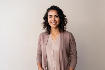 Medium shot portrait of an Indian woman in her 30s in a minimalist background