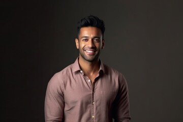 Fototapeta premium Medium shot portrait of an Indian man in his 30s in a minimalist background