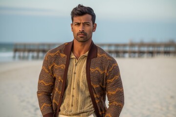 Lifestyle portrait of an Indian man in his 20s in a beach 