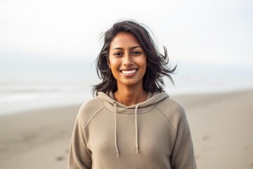 Lifestyle portrait of an Indian woman in her 30s in a beach 