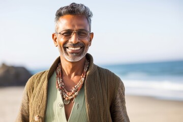 Portrait of smiling mature man standing at beach on a sunny day