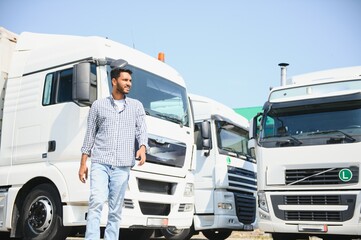 Young indian man standing by his truck. The concept of freight transportation.