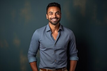 Portrait of a happy young Indian man smiling and looking at camera