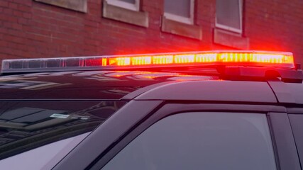Closeup of illuinating shiny police car lights in the city