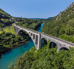 Fototapeta na wymiar An aerial view above the stone railway bridge on the outskirts of the town of Solkan in Slovenia in summertime