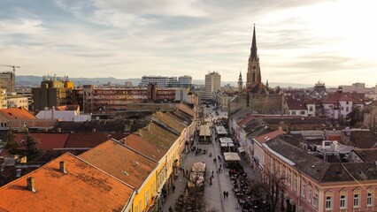 Obraz premium an aerial view of old town, with the tall tower of a church and steep