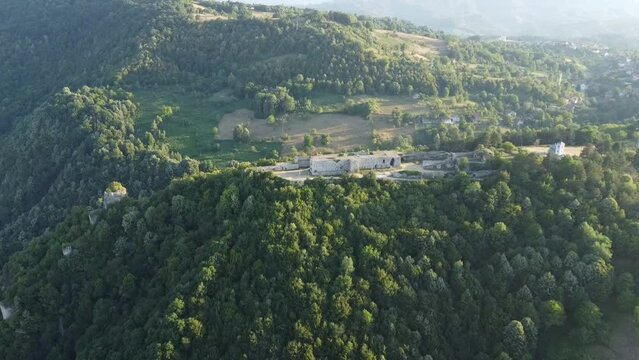 Aerial video of the abandoned building surrounded by mountains covered with trees, zvornik