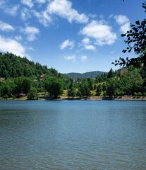 Fototapeta na wymiar Scenic view of a tranquil lake surrounded by greenery in Fuzina, Croatia
