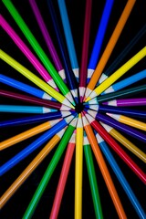 Color pencils against a black background.