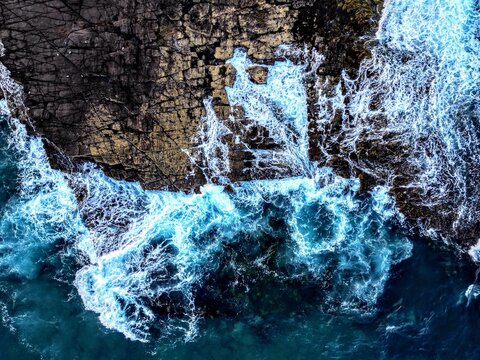 Dramatic scene of powerful waves crashing against the rocky shoreline