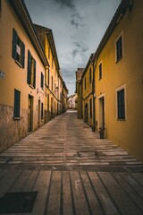 Fototapeta premium Vertical of an alleyway on a cloudy day in Alcudia on Mallorca, Spain
