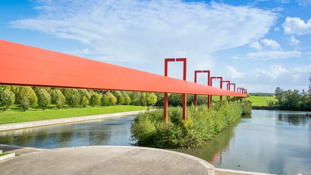 Pont Rouge in Cergy, France against a cloudy blue sky