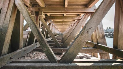 Close-up shot of wooden beams inside a bridge structure