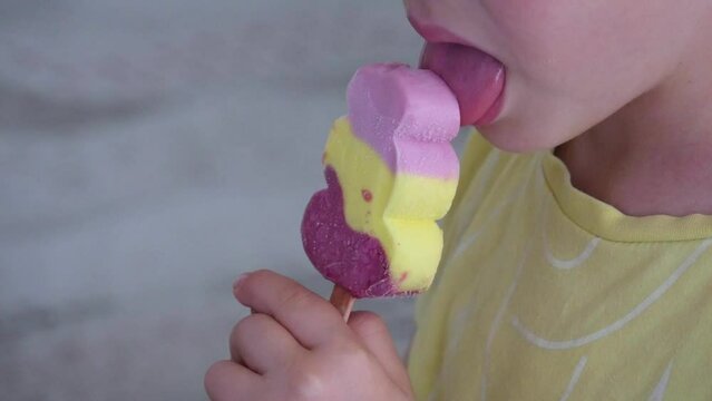a child tastefully licks popsicle ice cream