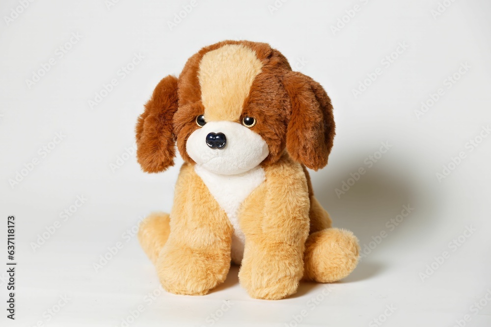 Wall mural Closeup of a stuffed brown dog toy on a white background - Wall murals