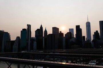 Fototapeta na wymiar Stunning view of the Lower Manhattan skyline, illuminated by the sunset