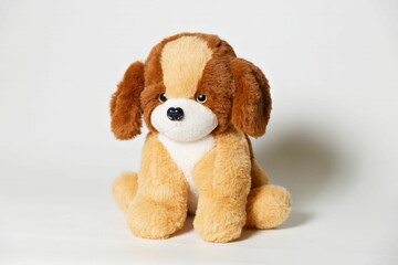 Closeup of a stuffed brown dog toy on a white background