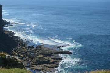 Sea view with a rocky shore on a sunny day