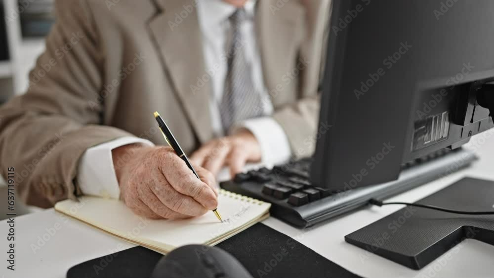 Poster middle age grey-haired man business worker using computer taking notes at office