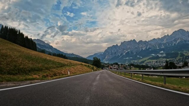 Point of view car driving on a mountain road in Dolomites Italy Alps. Travel and vacation on the road