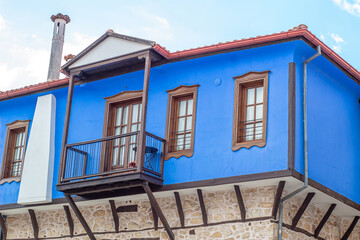 Fototapeta na wymiar Blue vintage old Greek house with wooden windows and door. Old 19th century architecture