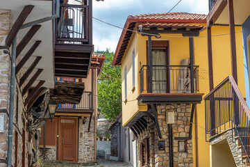 Fototapeta na wymiar Vintage cobblestone street with vintage houses in Greece