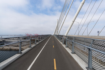View of the bicycle and pedestrian lane on the new Long Beach International Gateway Bridge leading to Terminal Island in Los Angeles County, California.