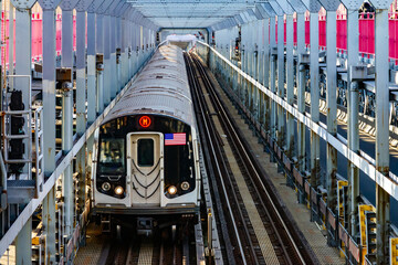 Subway train traveling on tracks across the Williamsburg Bridge from Brooklyn to Manhattan in New...