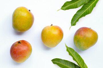 Sweet and juicy tropical fruit, Mango with green leaves on white background. Top view