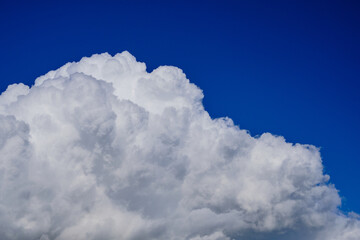 Naklejka na ściany i meble Big fluffy stormy clouds on blue sky