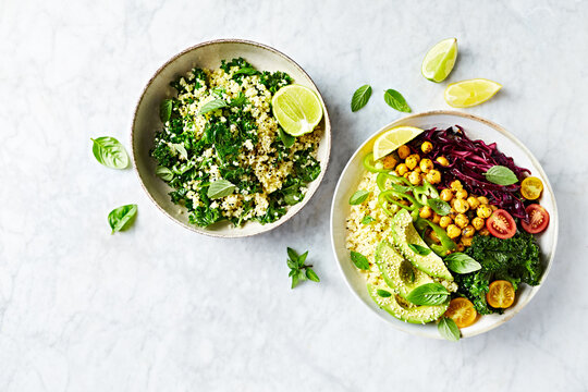 Colorful vegetable bowl with bulgur and chickpeas and kale-bulgur tabbouleh with garlic lime dressing. Top view. Copy space