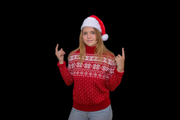 Light-eyed blonde girl with positive attitude in santa claus hat. Light-haired woman poses with hands up for new year or christmas product advertisement with wide smile and surprised face.