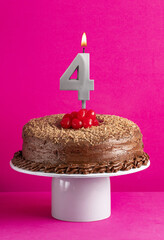 Number 4 candle - Chocolate cake on pink background