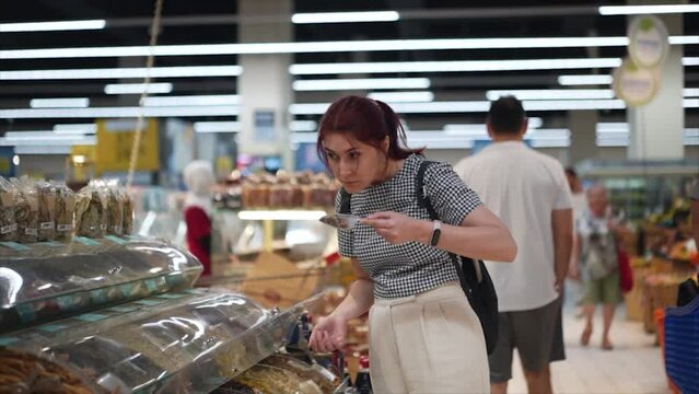 A young woman sniffs the fragrant spices. Spice bazaar